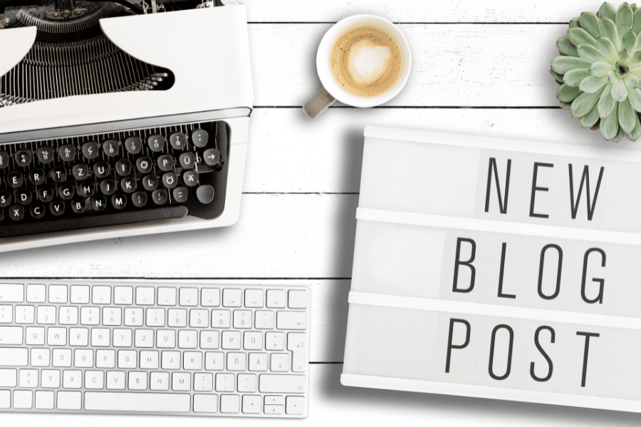 A sign reading "New Blog Post" next to a typewriter.